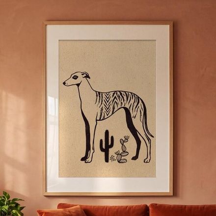 Brindle whippet print framed on a terracotta wall