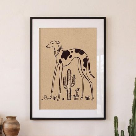 Spotted whippet print framed on a cream wall